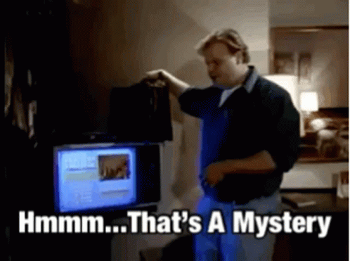 A Man Is Standing In Front Of A Computer And Says That 'S A Mystery GIF