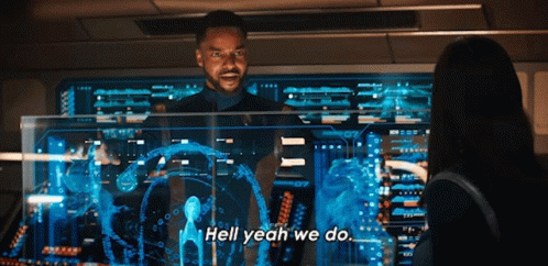 A Man Is Standing In Front Of A Computer Screen And Says Hell Yeah We Do GIF