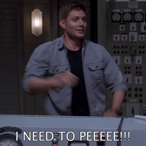 a man is standing in front of a control panel with the words ineed to peeeee written on it