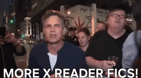 A Man Is Standing In Front Of A Crowd And Says More X Reader Fics ! GIF