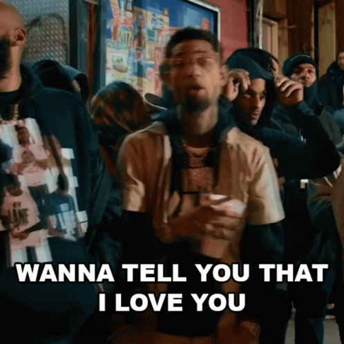 A Man Is Standing In Front Of A Crowd Of People And Saying `` Wanna Tell You That I Love You '' GIF