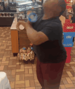 A Man Is Standing In Front Of A Display Of Oreos GIF
