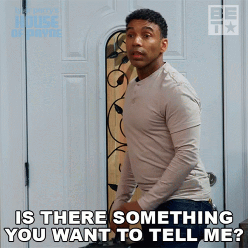 A Man Is Standing In Front Of A Door With The Words Is There Something You Want To Tell Me GIF