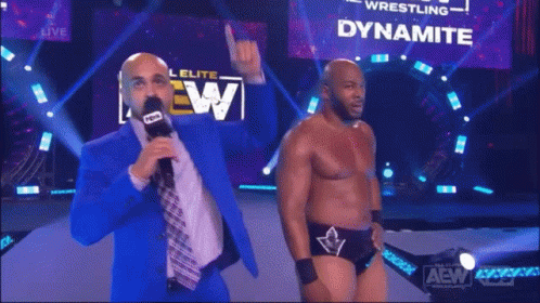 A Man Is Standing In Front Of A Dynamite Sign GIF