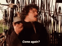 A Man Is Standing In Front Of A Fence Talking On A Cell Phone And Asking To Come Again . GIF