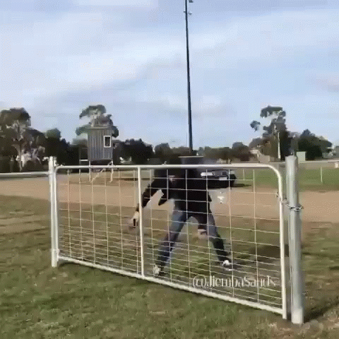 A Man Is Standing In Front Of A Fence That Says ' Glenn ' On It GIF