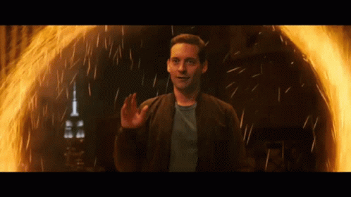 A Man Is Standing In Front Of A Fire Ring GIF