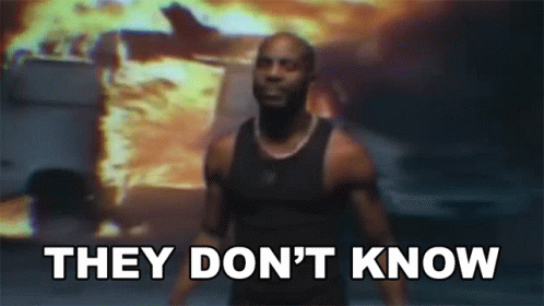 A Man Is Standing In Front Of A Fire With The Words " They Don 'T Know " GIF
