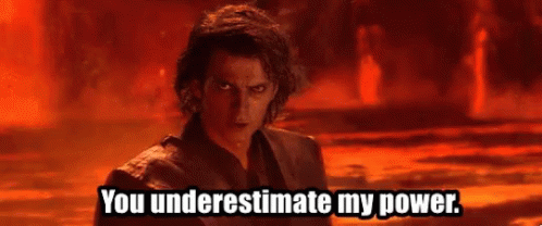 A Man Is Standing In Front Of A Fire With The Words `` You Underestimate My Power '' Written On It . GIF