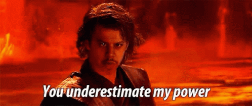 A Man Is Standing In Front Of A Fire With The Words `` You Underestimate My Power '' Written On The Screen . GIF