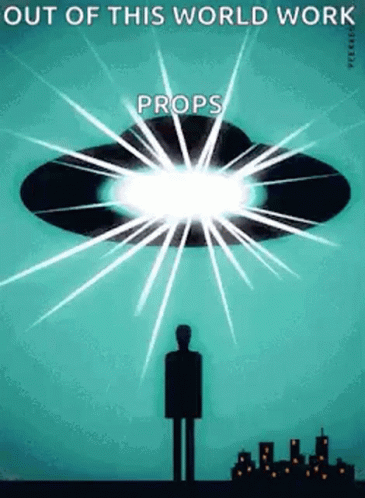 A Man Is Standing In Front Of A Flying Saucer With The Words Out Of This World Work Props Written On It . GIF