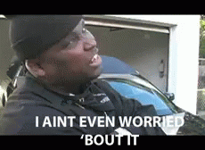 A Man Is Standing In Front Of A Garage With The Words I Aint Even Worried Bout It GIF