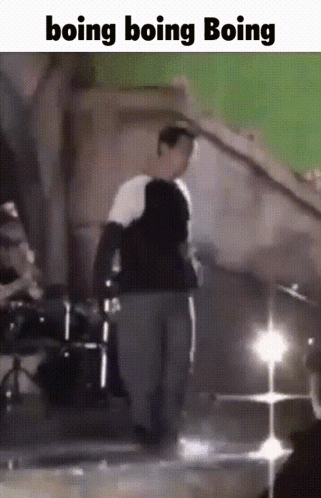 A Man Is Standing In Front Of A Green Screen With The Words Boing Boing Boing GIF