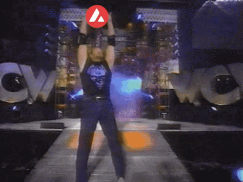 A Man Is Standing In Front Of A Huge Explosion With A Red Arrow Pointing To His Chest GIF