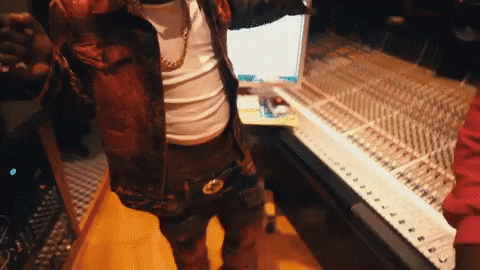 A Man Is Standing In Front Of A Keyboard In A Room GIF