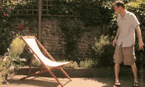 A Man Is Standing In Front Of A Lawn Chair With The Website Sheepplace.co.uk Written On The Bottom GIF