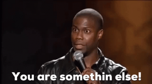 a man is standing in front of a microphone and saying `` you are somethin else ! ''