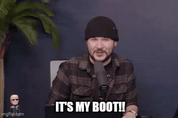 A Man Is Standing In Front Of A Microphone And Says It 'S My Boot . GIF