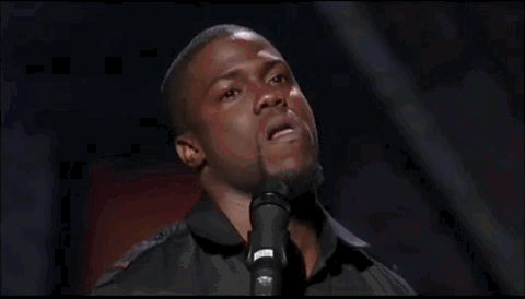 A Man Is Standing In Front Of A Microphone And Singing Into It . GIF
