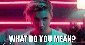 A Man Is Standing In Front Of A Neon Sign And Asking What Do You Mean ? GIF