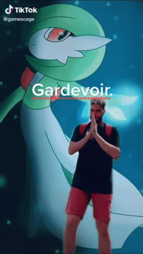A Man Is Standing In Front Of A Pokemon Named Gardevoir GIF