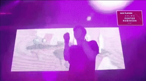A Man Is Standing In Front Of A Purple Screen That Says Porter Robinson GIF