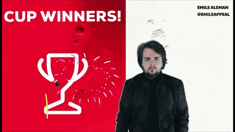 A Man Is Standing In Front Of A Red And White Poster That Says Cup Winners GIF
