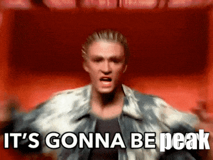 A Man Is Standing In Front Of A Red Background And Says It 'S Gonna Be Peak GIF