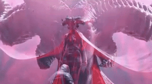 A Man Is Standing In Front Of A Red Dragon With A Sword . GIF
