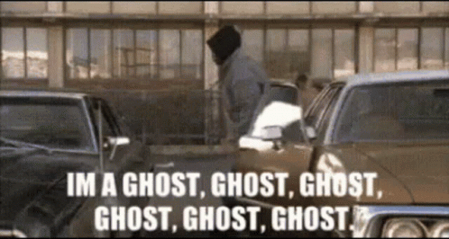 A Man Is Standing In Front Of A Row Of Cars And Says Im A Ghost Ghost Ghost Ghost GIF