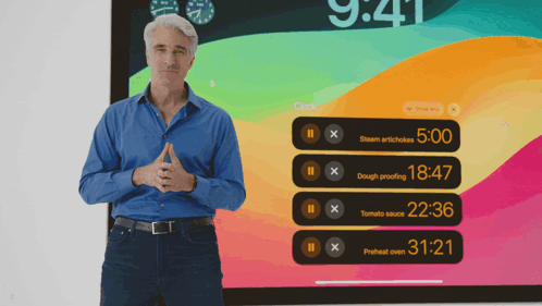 A Man Is Standing In Front Of A Screen That Says 9:41 GIF