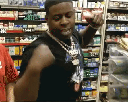 a man is standing in front of a shelf with a price tag of $ 549