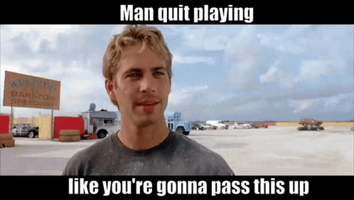 A Man Is Standing In Front Of A Sign That Says Barstow Speedway GIF