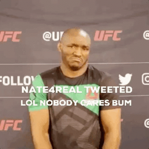 A Man Is Standing In Front Of A Sign That Says Follow Nate4real Tweeted Lol Nobody Cares Bum GIF