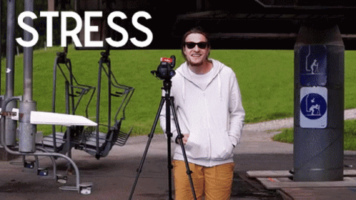 A Man Is Standing In Front Of A Sign That Says " Stress " GIF