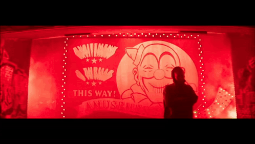 A Man Is Standing In Front Of A Sign That Says This Way ! GIF