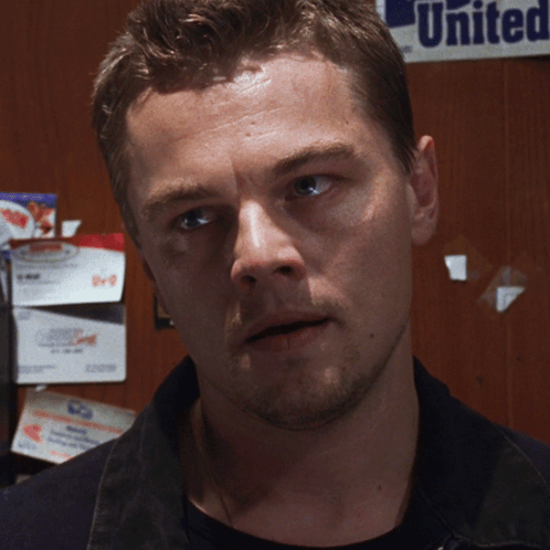 A Man Is Standing In Front Of A Sign That Says United GIF
