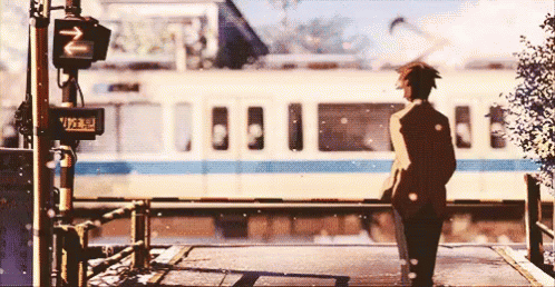 A Man Is Standing In Front Of A Train With A Sign That Says ' N ' On It GIF