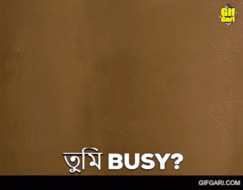 A Man Is Standing In Front Of A Wall And Says " Busy " In A Foreign Language GIF