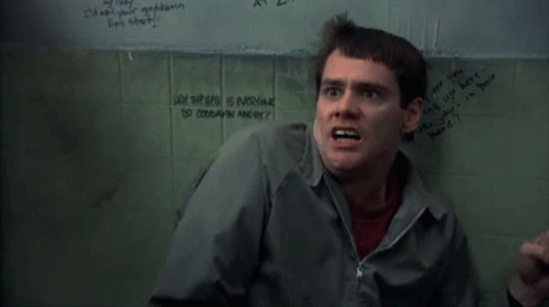 A Man Is Standing In Front Of A Wall That Says " Why The Hell Is Everyone So Goddamn Angry " On It GIF