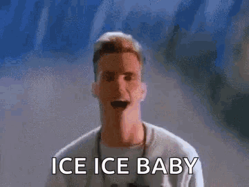 A Man Is Standing In Front Of A Wall With The Words Ice Ice Baby On It . GIF