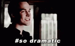 A Man Is Standing In Front Of A Window With The Words `` So Dramatic '' Written Below Him . GIF