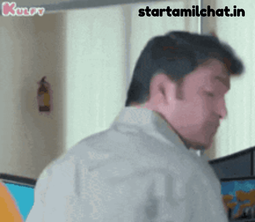 A Man Is Standing In Front Of A Window With The Words Starttamilchat.in Written On The Bottom GIF