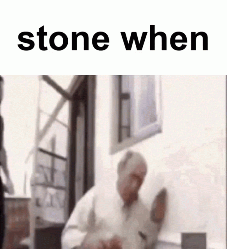 A Man Is Standing In Front Of A Window With The Words `` Stone When '' On The Bottom . GIF