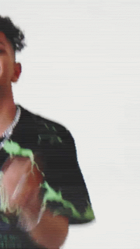 A Man Is Standing In Front Of A Yellow Background GIF