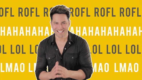 A Man Is Standing In Front Of A Yellow Background That Says Lol GIF
