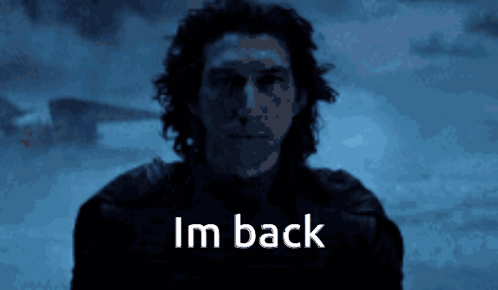 A Man Is Standing In The Dark And The Words Im Back Are Visible GIF