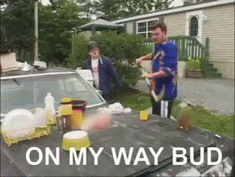 A Man Is Standing Next To A Car With The Words On My Way Bud GIF