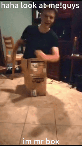 A Man Is Standing Next To A Cardboard Box That Says Im Mr Box On It GIF