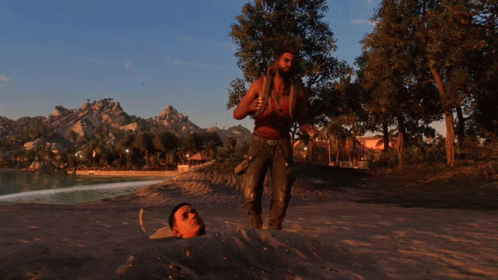 A Man Is Standing Next To A Man Buried In The Sand GIF
